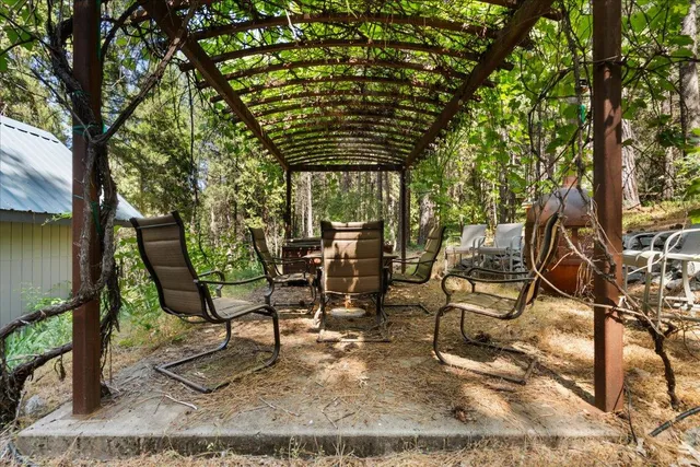 a view of patio with table and chairs and potted plants