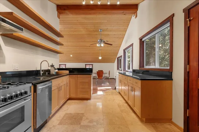 a kitchen with stainless steel appliances granite countertop a stove and a sink