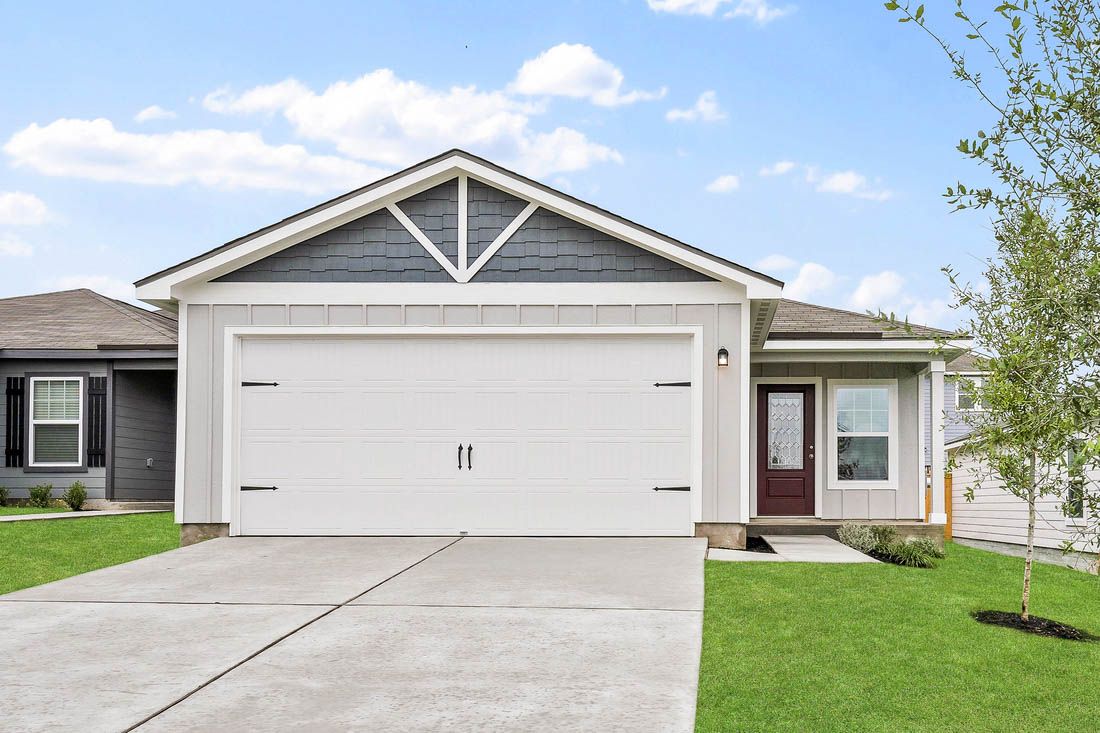 a front view of white house with a yard