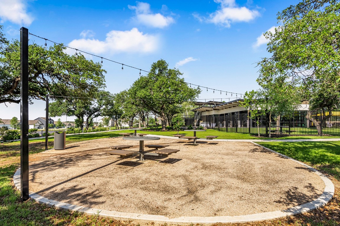 129 Morrison Drive Jarrell, TX 76537 - Photo 11 of 11 a view of a swimming pool and trees in the background