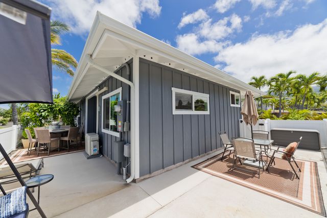 a building outdoor space with patio furniture and potted plants