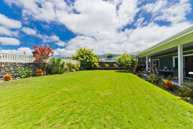 a view of a house with a yard garden and patio