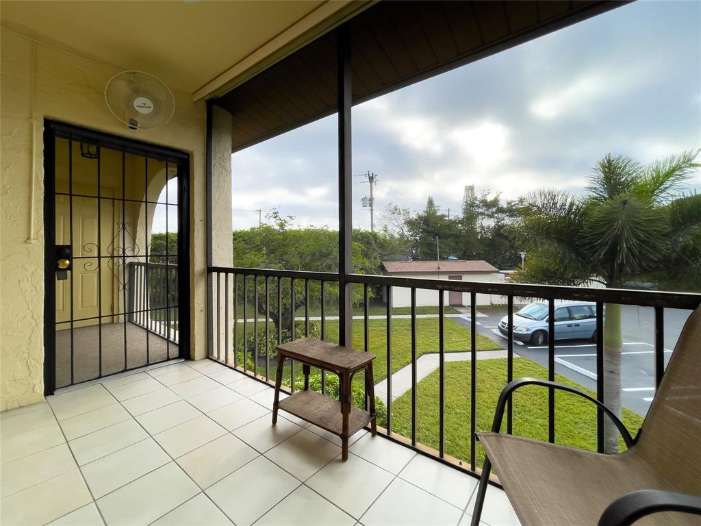 317 Knotty Pine Circle, Unit C2 Greenacres, FL 33463 - Photo 12 of 51 a balcony with chairs