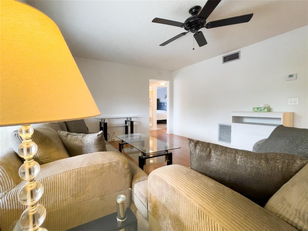 317 Knotty Pine Circle, Unit C2 Greenacres, FL 33463 - Photo 13 of 51 a living room with couches and a floor to ceiling window