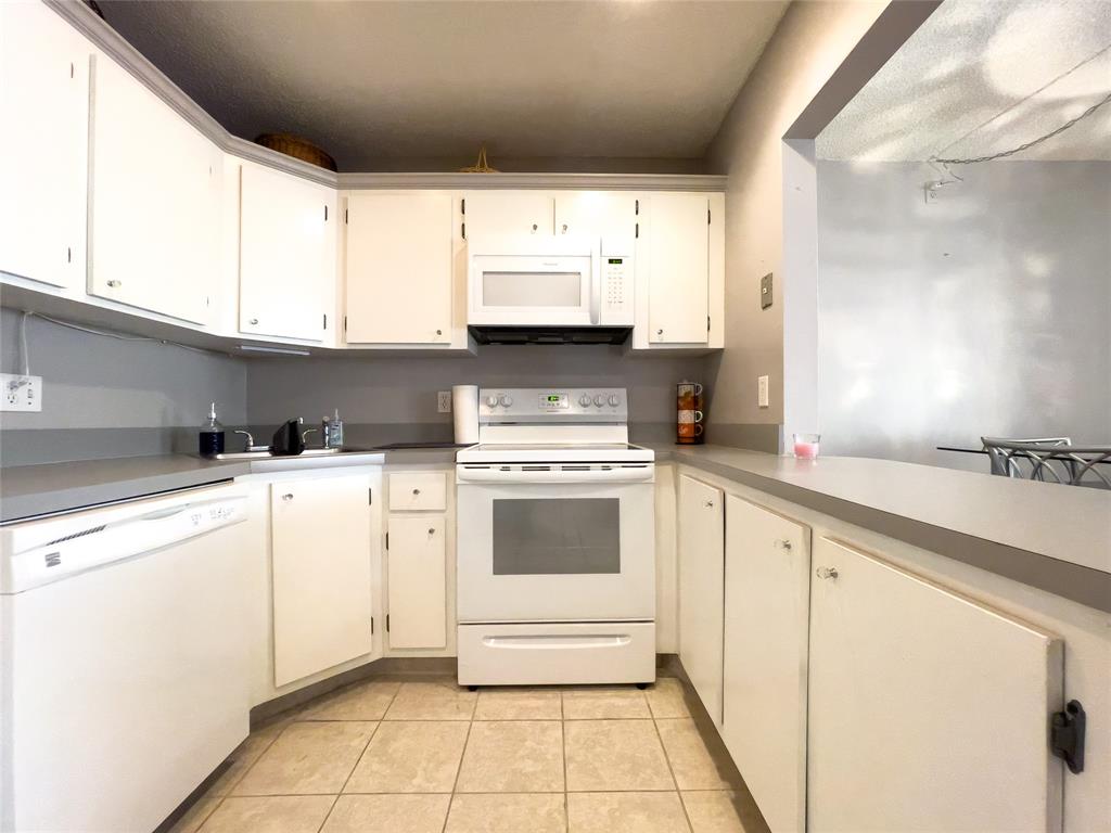 317 Knotty Pine Circle, Unit C2 Greenacres, FL 33463 - Photo 14 of 51 a kitchen with a white cabinets and white appliances