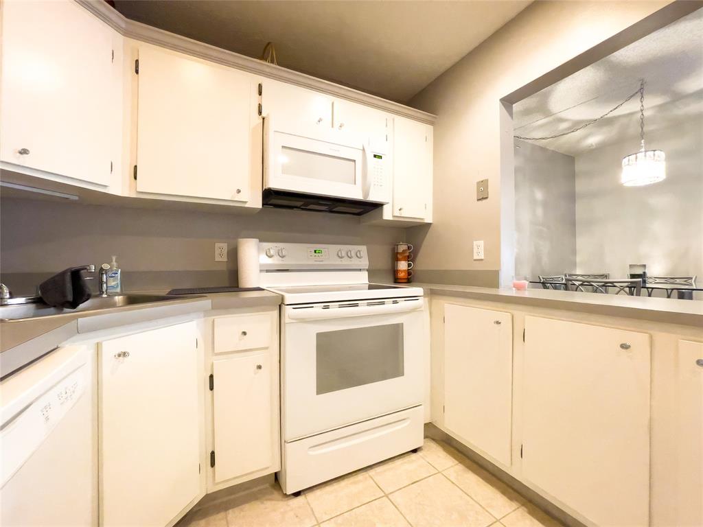 317 Knotty Pine Circle, Unit C2 Greenacres, FL 33463 - Photo 16 of 51 a kitchen with granite countertop white cabinets and white appliances