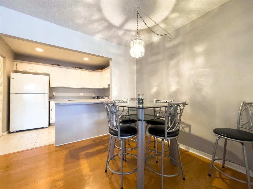 317 Knotty Pine Circle, Unit C2 Greenacres, FL 33463 - Photo 17 of 51 a kitchen with a table and chairs in it