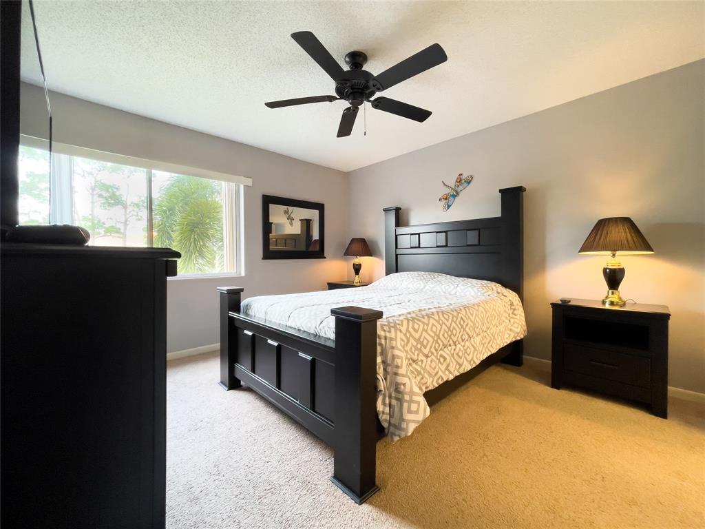 317 Knotty Pine Circle, Unit C2 Greenacres, FL 33463 - Photo 19 of 51 a bed room with a bed and a television