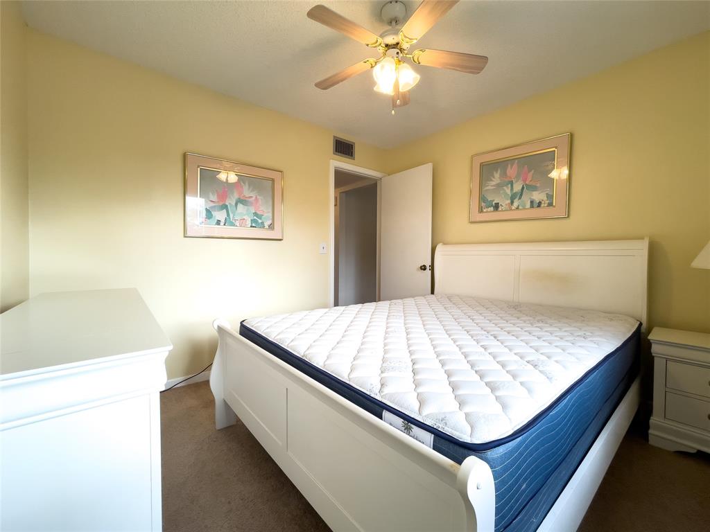 317 Knotty Pine Circle, Unit C2 Greenacres, FL 33463 - Photo 20 of 51 a bedroom with a bed and painting on the wall