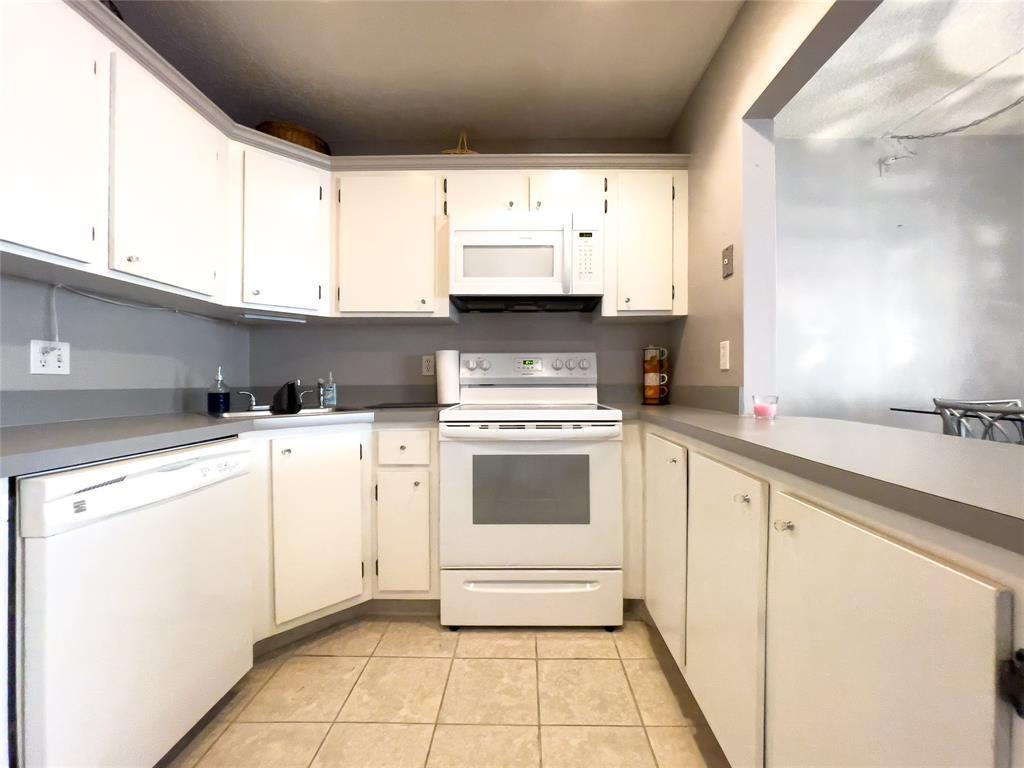 317 Knotty Pine Circle, Unit C2 Greenacres, FL 33463 - Photo 26 of 51 a kitchen with white cabinets and white appliances