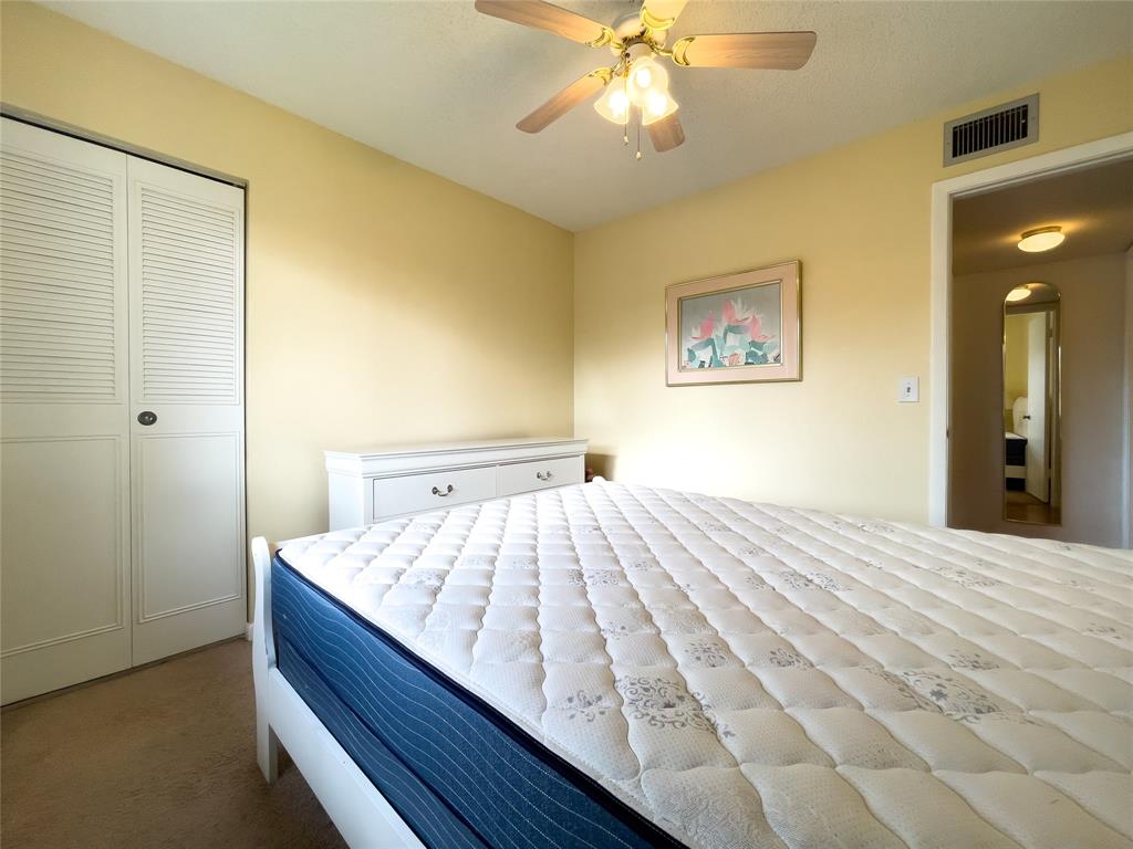 317 Knotty Pine Circle, Unit C2 Greenacres, FL 33463 - Photo 29 of 51 a bedroom with a bed and a chandelier