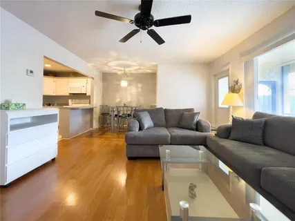 a living room with furniture and a wooden floor