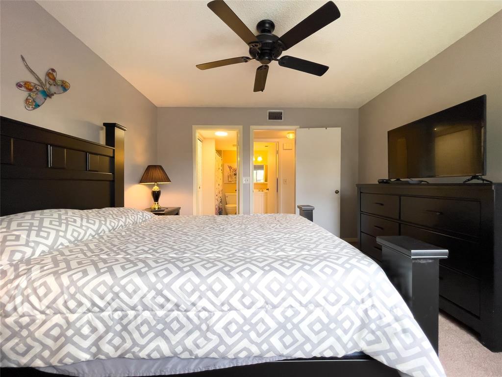 317 Knotty Pine Circle, Unit C2 Greenacres, FL 33463 - Photo 32 of 51 a bedroom with a bed and wooden floor