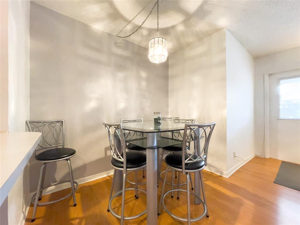 317 Knotty Pine Circle, Unit C2 Greenacres, FL 33463 - Photo 4 of 51 a view of a dining room with furniture and wooden floor