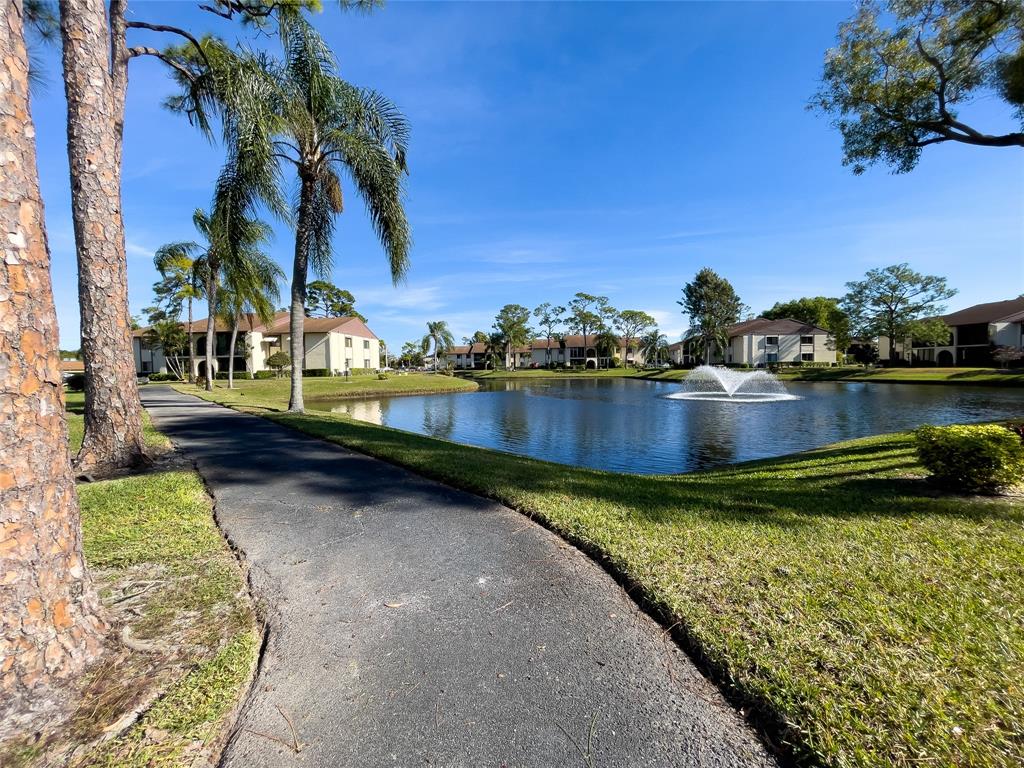 317 Knotty Pine Circle, Unit C2 Greenacres, FL 33463 - Photo 45 of 51 a view of a lake with houses