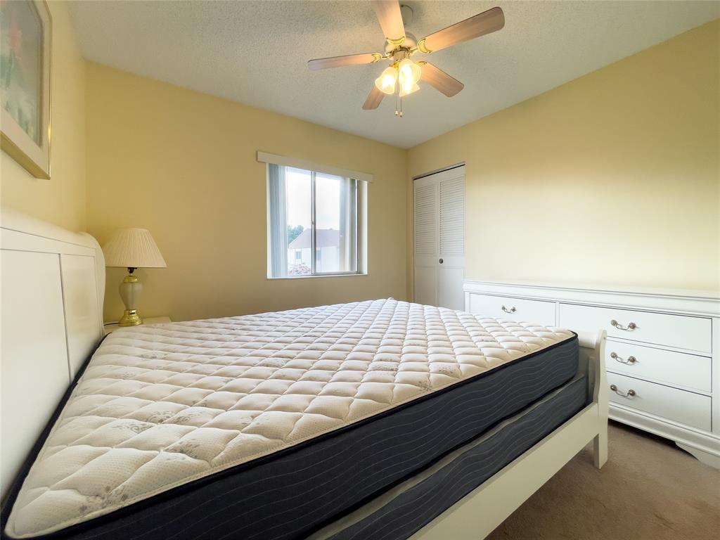 317 Knotty Pine Circle, Unit C2 Greenacres, FL 33463 - Photo 6 of 51 a bed sitting in a bedroom next to a window