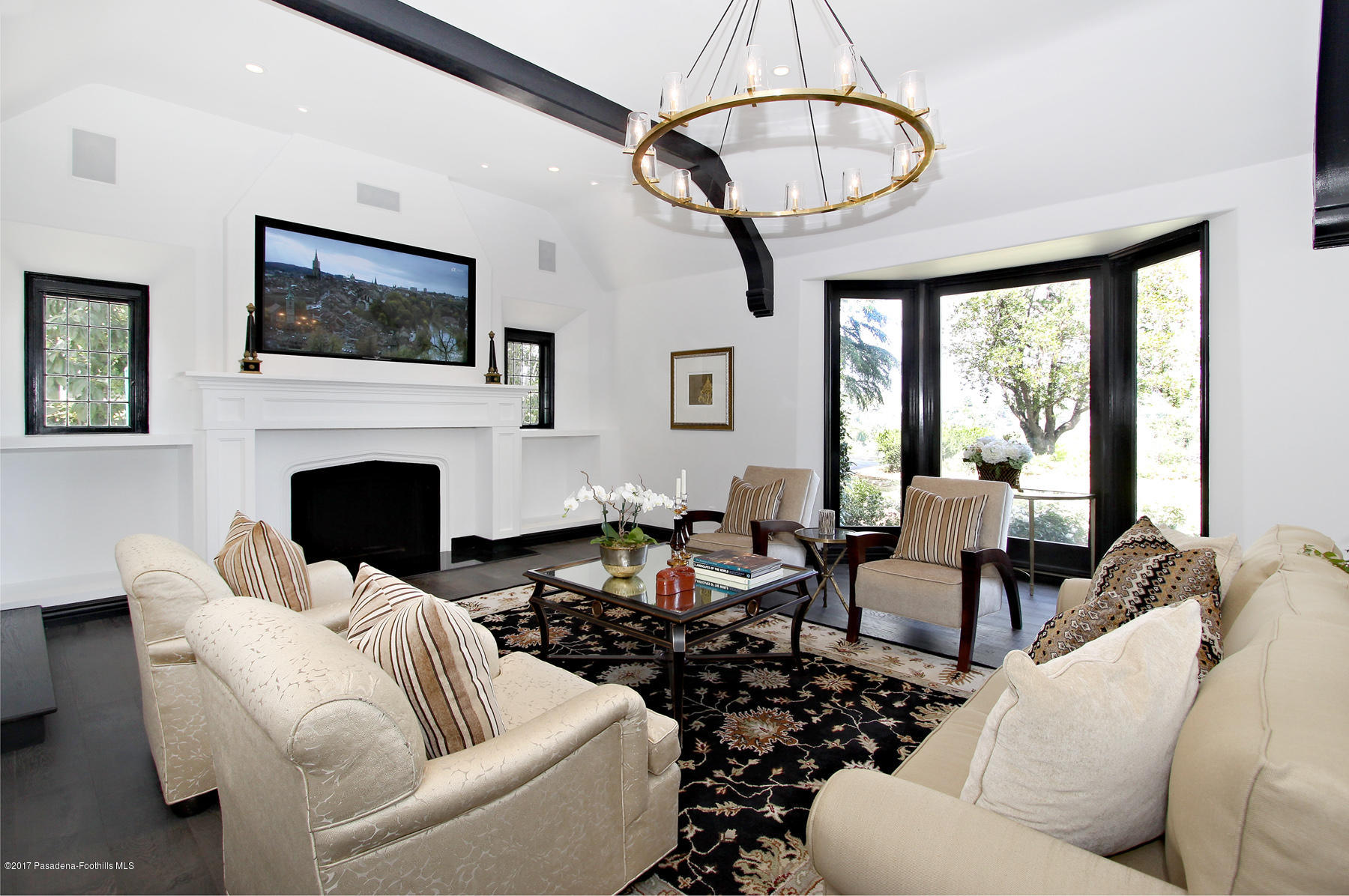1415 Parkview Avenue Pasadena, CA 91103 - Photo 8 of 35 a living room with furniture a fireplace and a chandelier