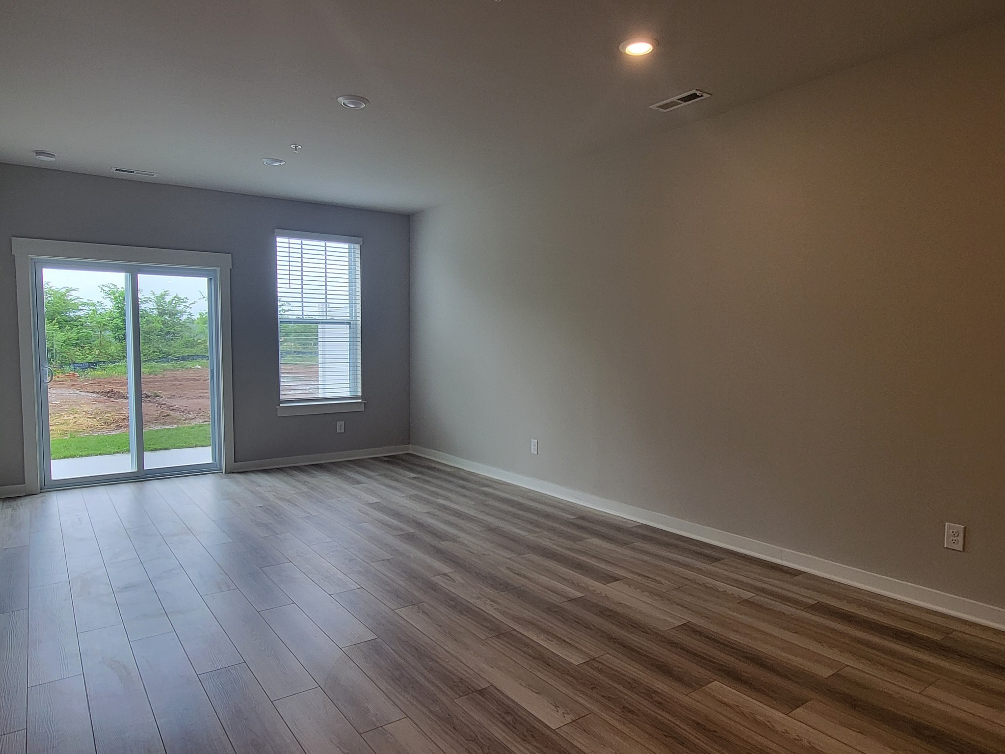 382 Casper Drive Spring Hill, TN 37174 - Photo 2 of 16 a view of an empty room with wooden floor and a window