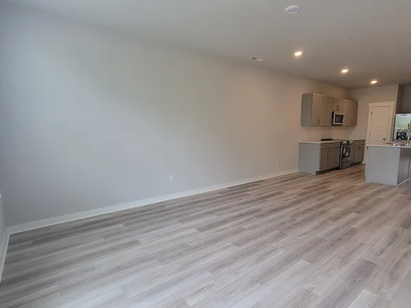 a view of kitchen with wooden floor and electronic appliances