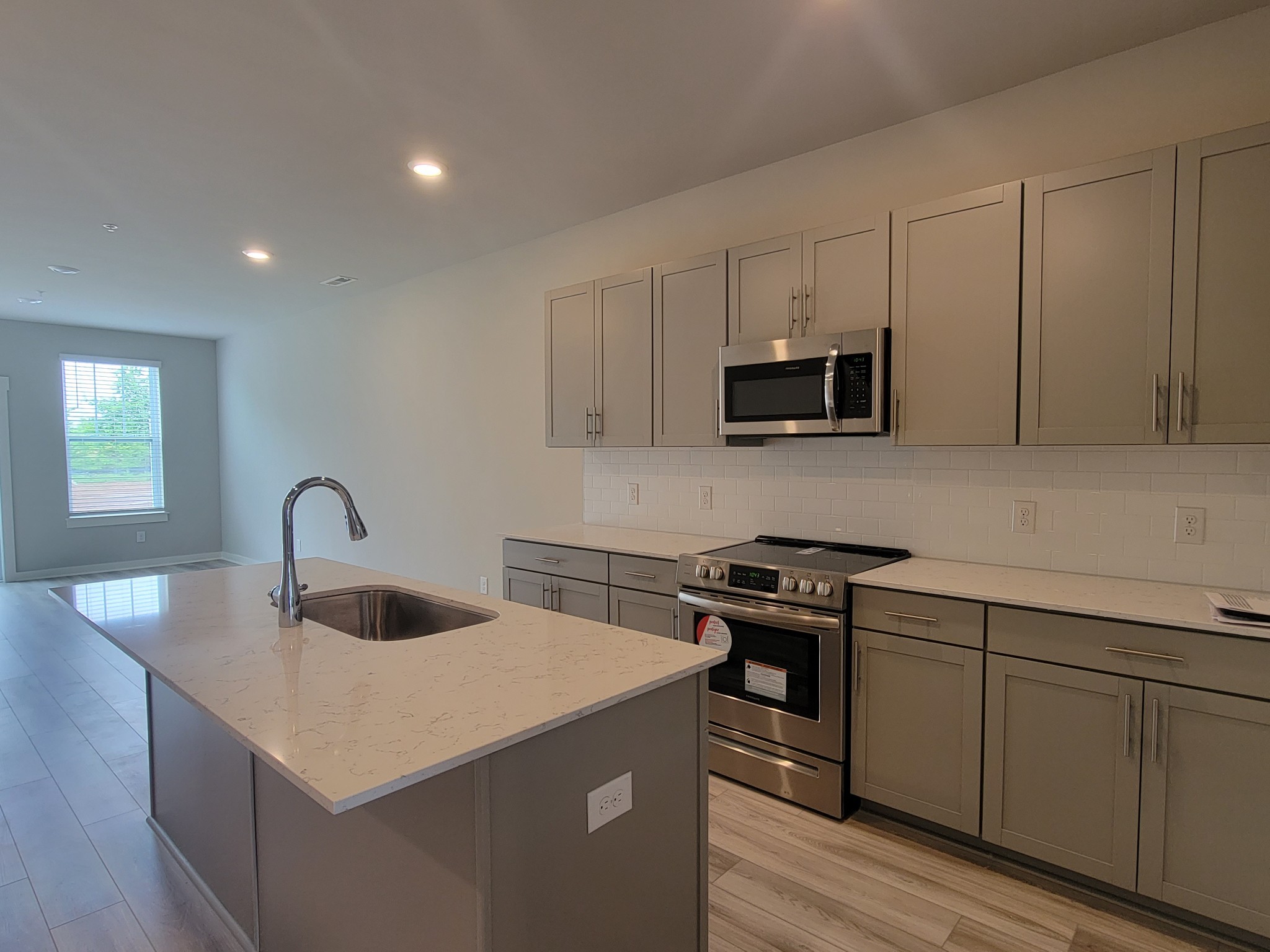 382 Casper Drive Spring Hill, TN 37174 - Photo 5 of 16 a kitchen with sink a microwave and stove