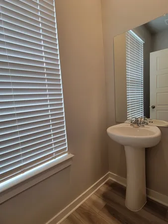 a bathroom with a sink a mirror and a window