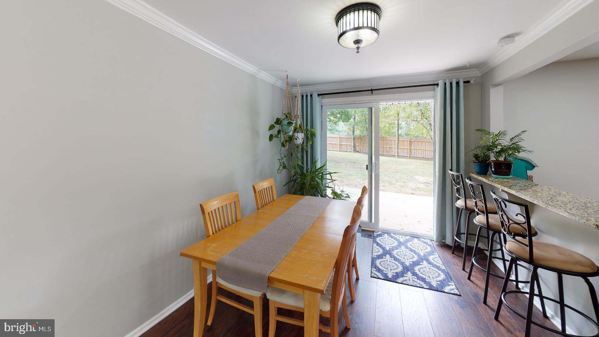 7808 Metacomet Road Hanover, MD 21076 - Photo 4 of 33 Bright and Sunny Dining Area steps down to patio
