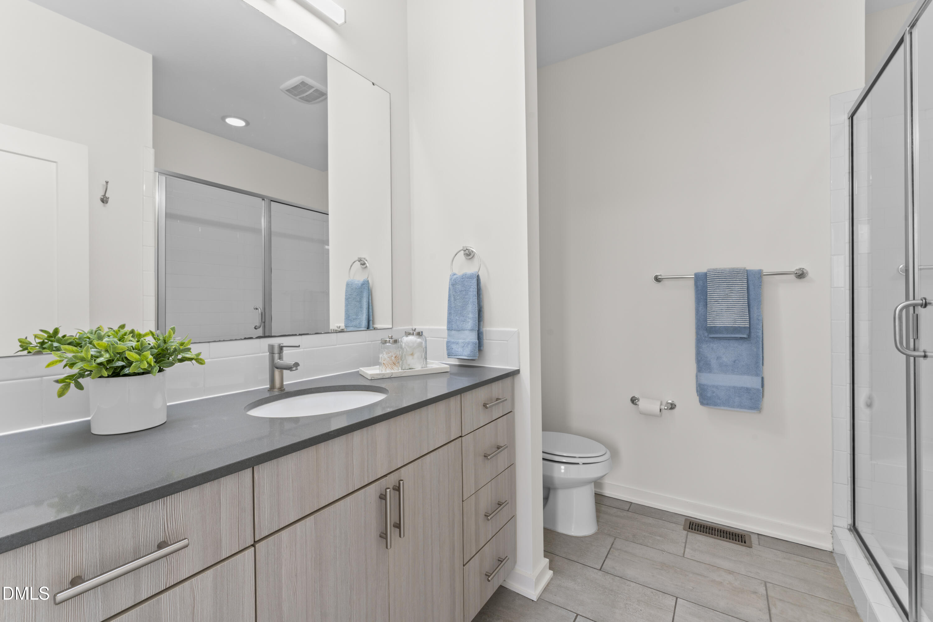 536 South Person Street Raleigh, NC 27601 - Photo 13 of 38 a bathroom with a granite countertop sink a toilet and a mirror
