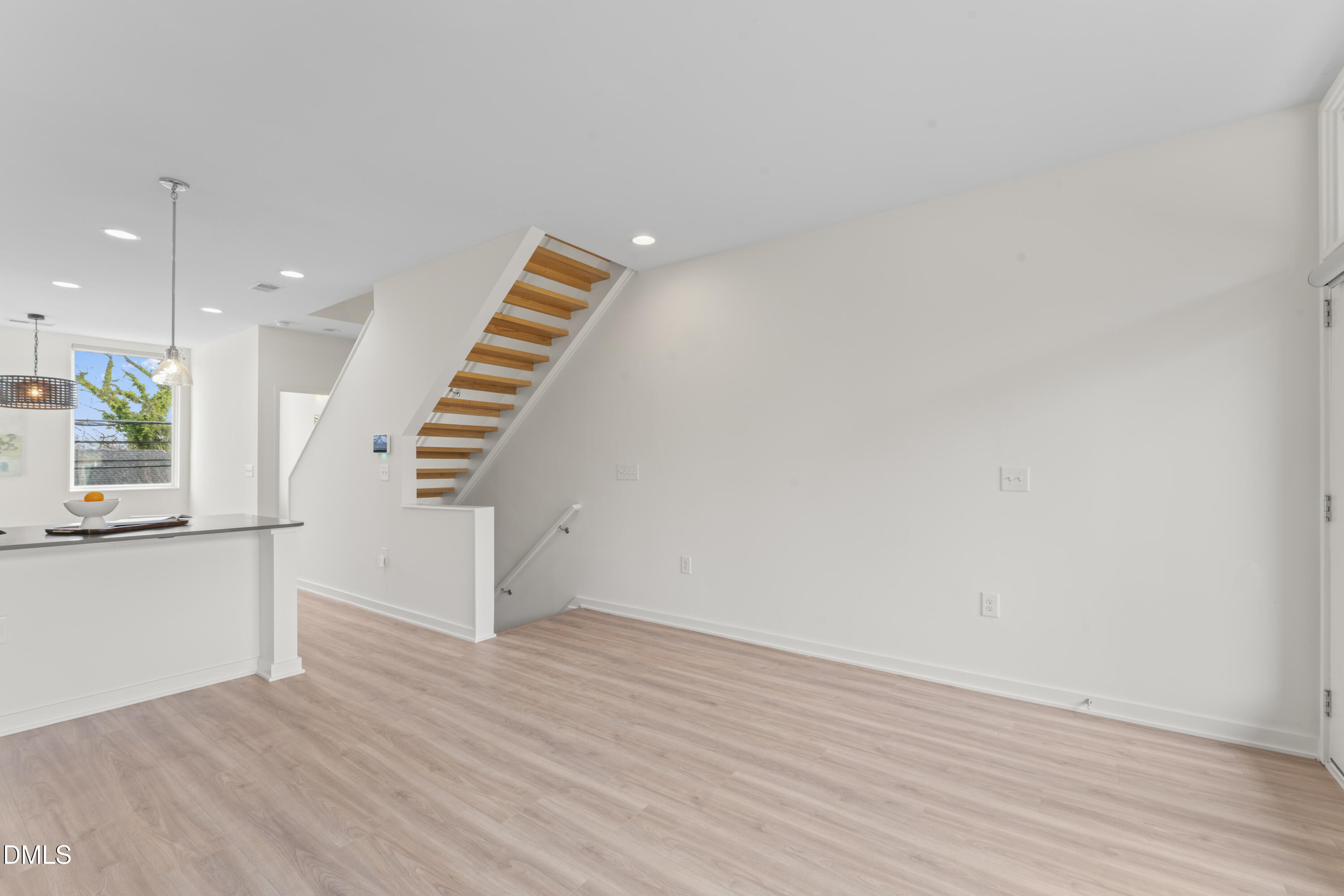 536 South Person Street Raleigh, NC 27601 - Photo 20 of 38 a view of an empty room with wooden floor and stairs