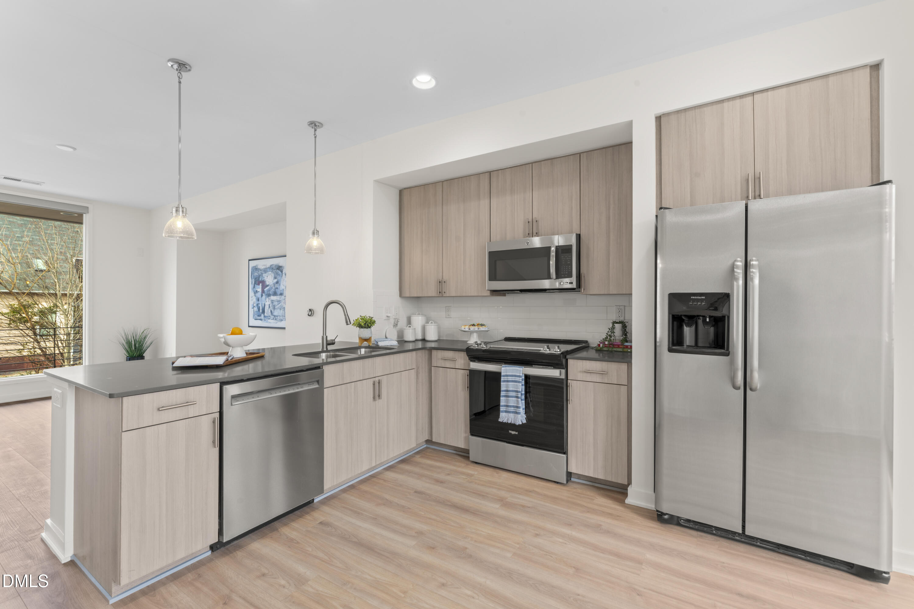 536 South Person Street Raleigh, NC 27601 - Photo 21 of 38 a kitchen with a sink stainless steel appliances and white cabinets