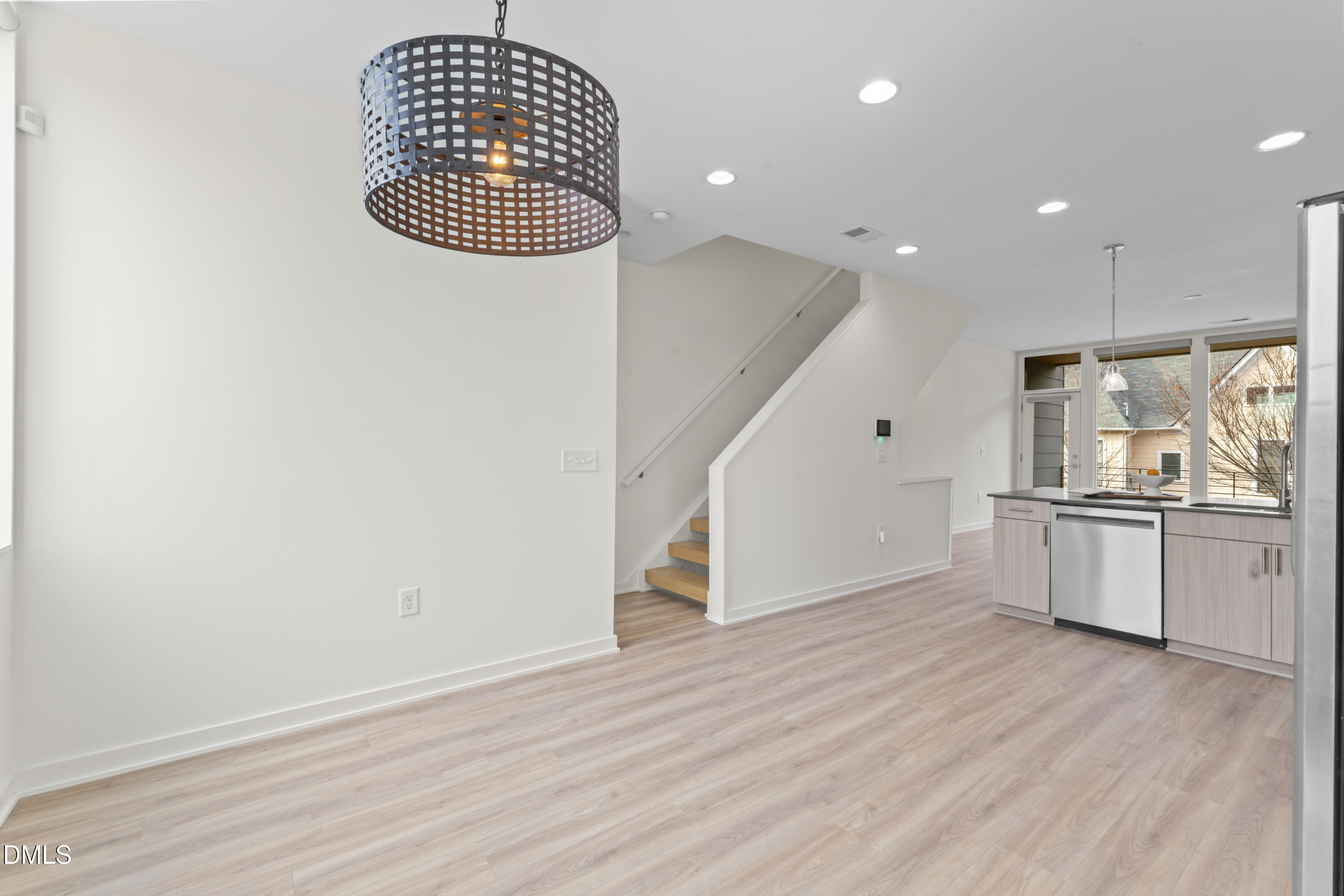 536 South Person Street Raleigh, NC 27601 - Photo 23 of 38 an empty room with wooden floor kitchen view and a window