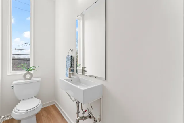 a kitchen with a sink stainless steel appliances and white cabinets