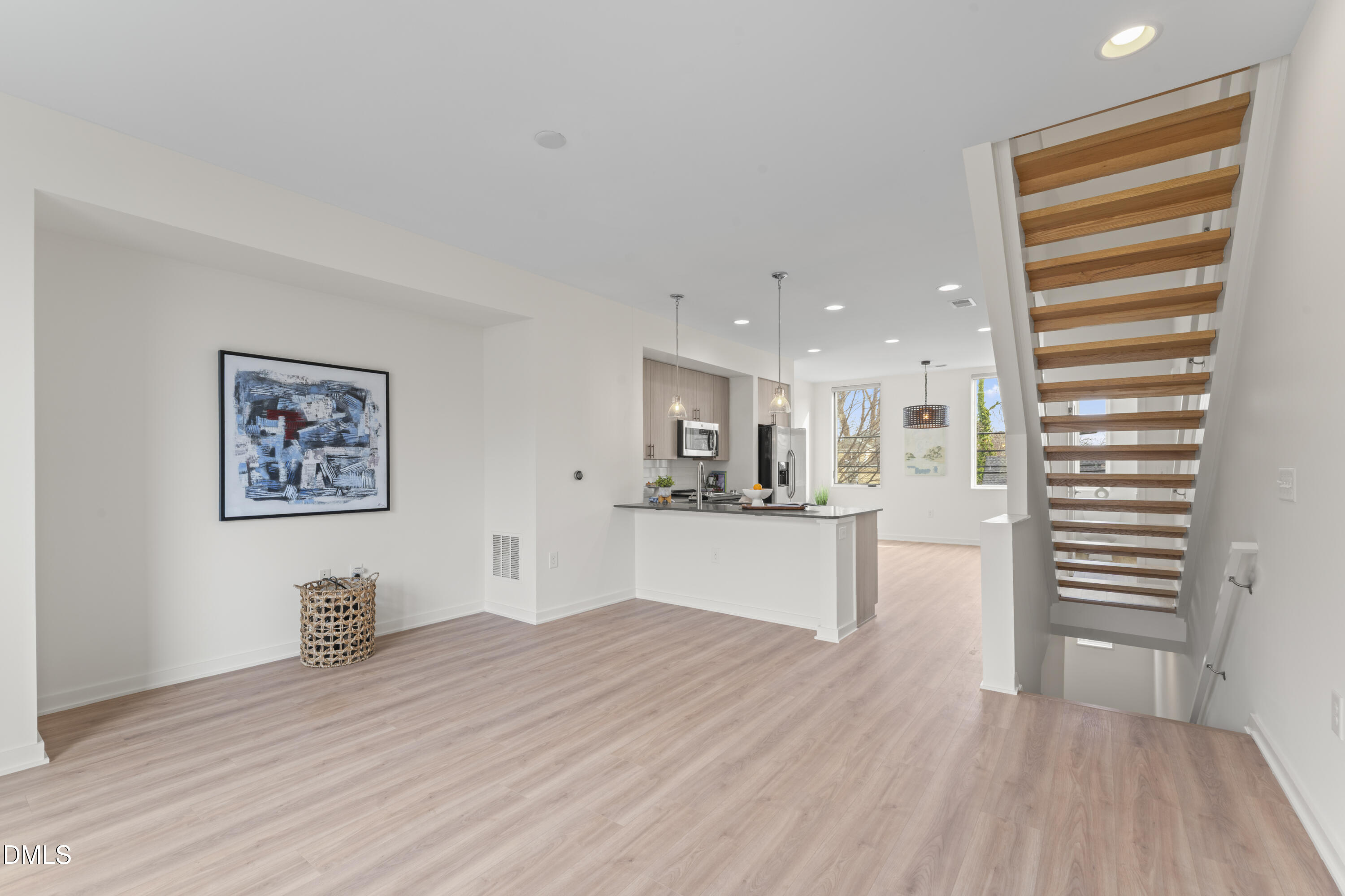 536 South Person Street Raleigh, NC 27601 - Photo 3 of 38 a view of a kitchen with kitchen island wooden floor center island and stainless steel appliances