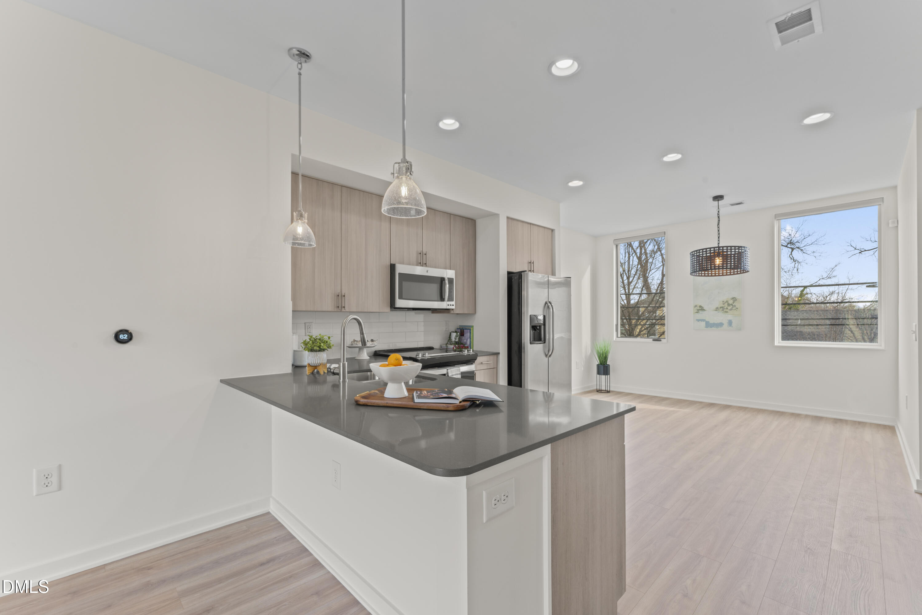 536 South Person Street Raleigh, NC 27601 - Photo 4 of 38 a kitchen with stainless steel appliances granite countertop a sink refrigerator and microwave