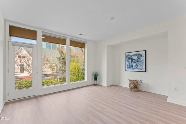 a view of a kitchen with kitchen island wooden floor center island and stainless steel appliances