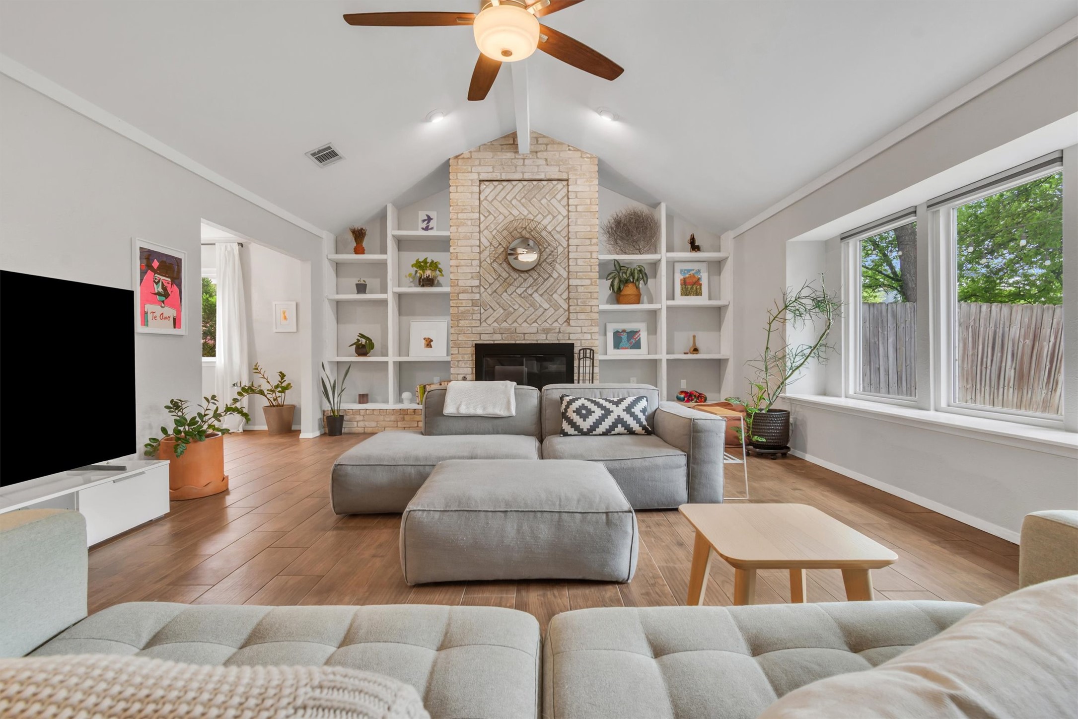 10809 Parkfield Drive Austin, TX 78758 - Photo 1 of 24 Herringbone fireplace, built-in bookcases, vaulted ceiling — genuine character