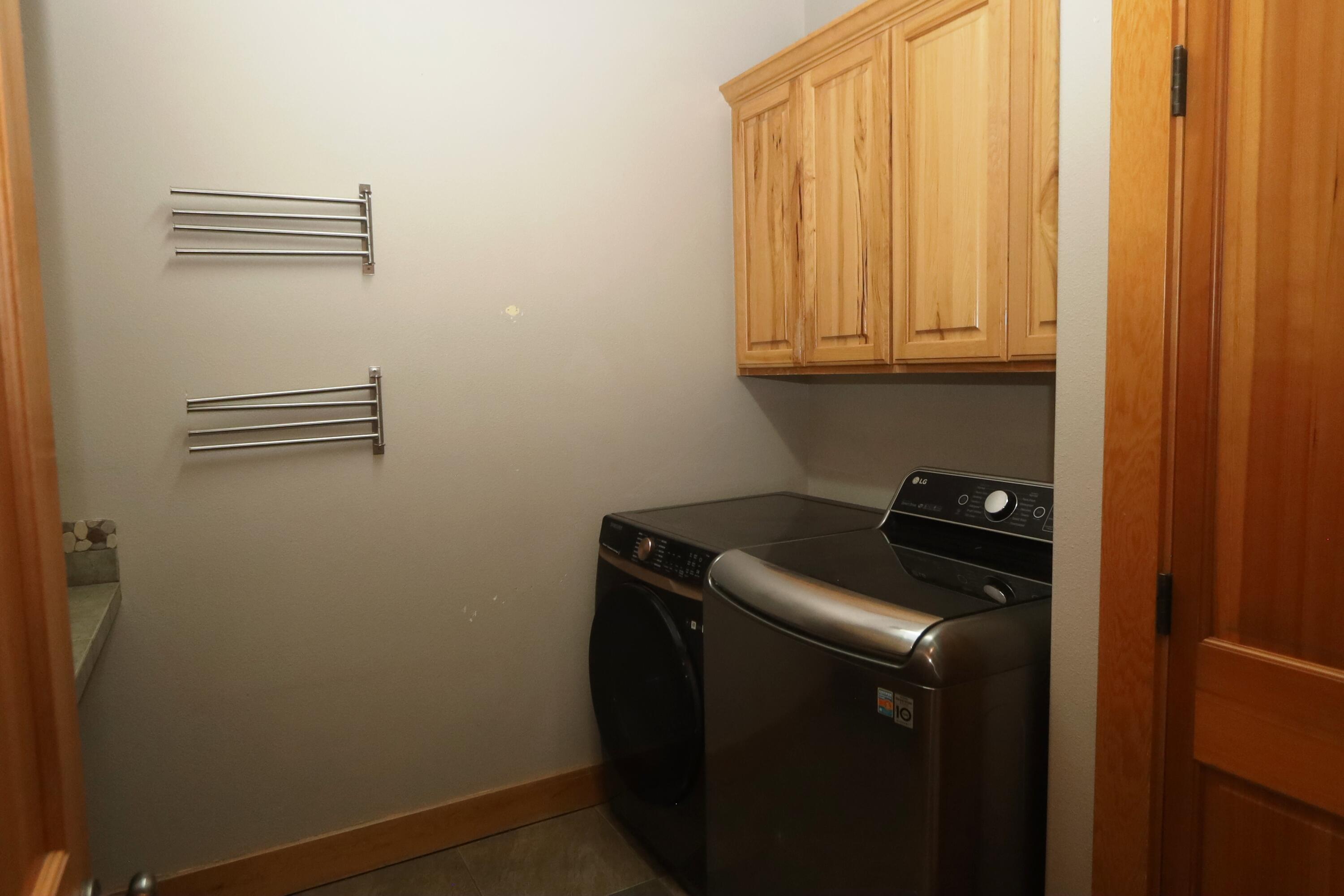 21491 Bear Creek Road Bend, OR 97701 - Photo 23 of 45 a utility room with wooden floor