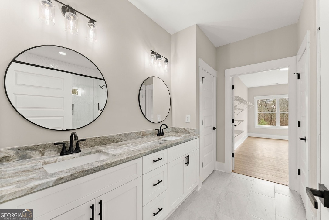 206 Shoals Way Clarkesville, GA 30523 - Photo 11 of 34 a bathroom with a granite countertop double vanity sink and a mirror