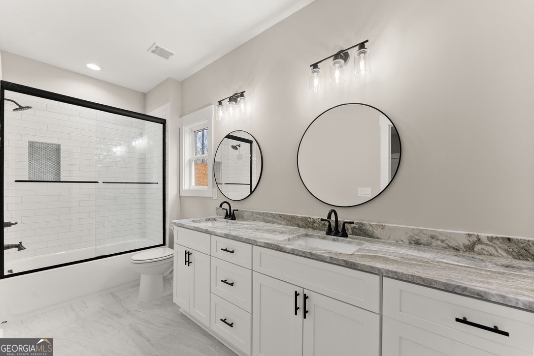 206 Shoals Way Clarkesville, GA 30523 - Photo 30 of 49 The jack n jill bath is located in the back of the home serving bedrooms 3 to 4. With it's double vanity and extended counters, this space provides plenty of cabinets and drawers for all your storage needs.