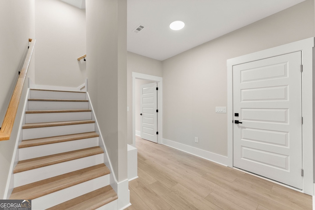 206 Shoals Way Clarkesville, GA 30523 - Photo 32 of 49 Located just off the mudroom, the stairs lead up to the bonus room.