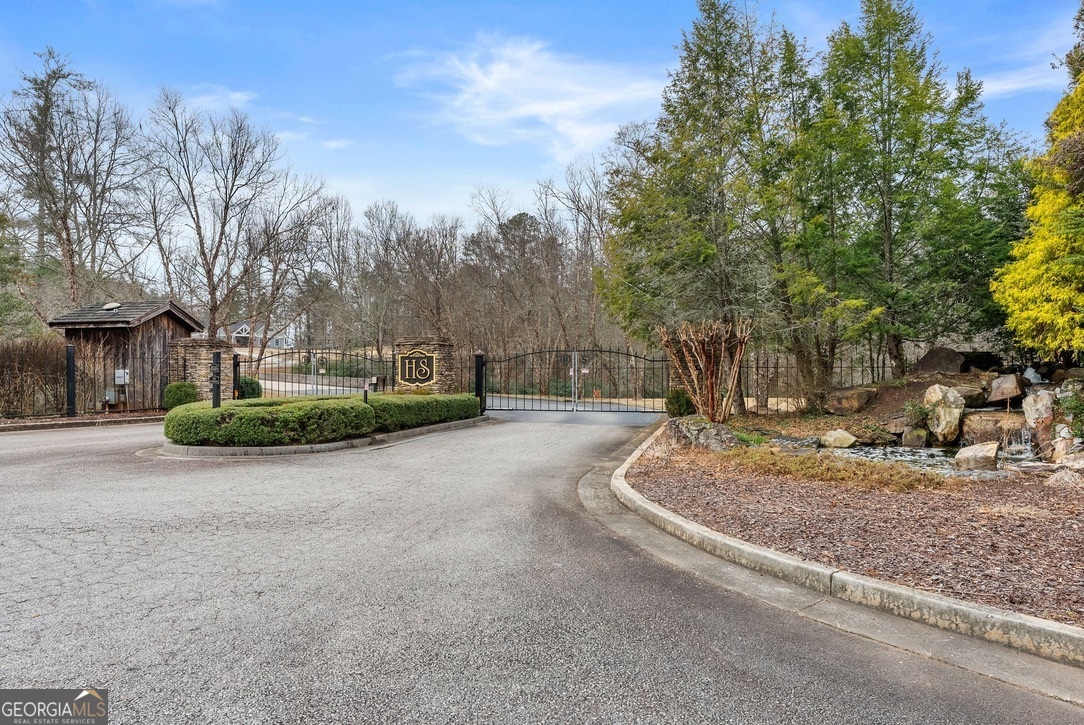 206 Shoals Way Clarkesville, GA 30523 - Photo 46 of 49 The beautiful gated entrance is adorned with a waterfall, stonework, community mailboxes and beautiful landscaping.