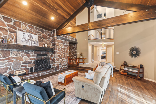 460 Omni Point Road Central Valley, UT 84754 - Photo 10 of 101 Spacious living area featuring a vaulted wood-paneled ceiling with exposed beams, a stone fireplace with a substantial wood mantel, recessed lighting,