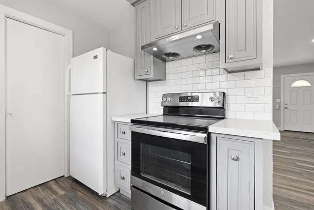 a kitchen with a stove and a refrigerator