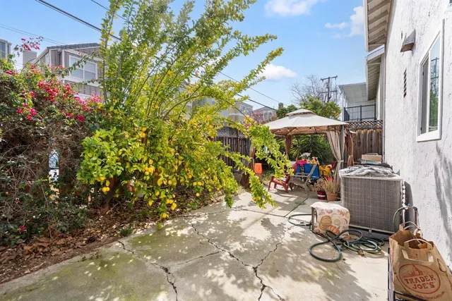 a backyard of a house with table and chairs