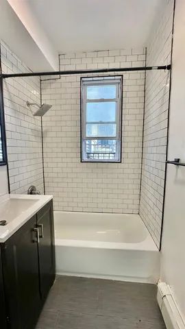 a bathroom with a shower curtain and a bath tub