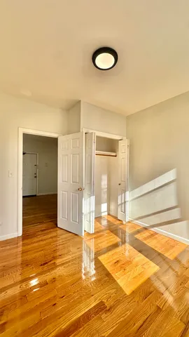 a view of a livingroom with wooden floor and a sink