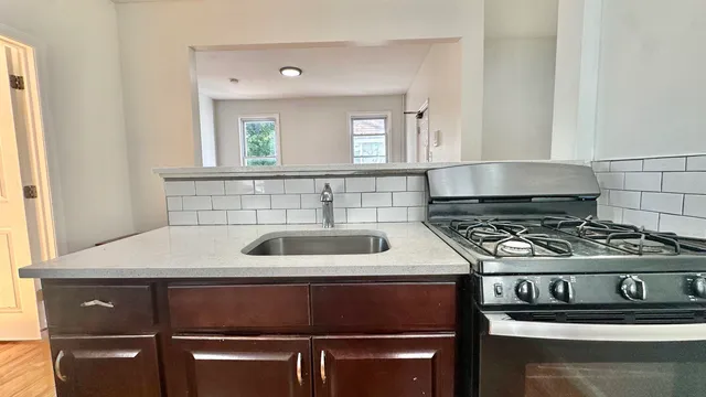 a white stove top oven sitting inside of a kitchen