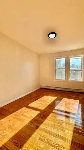 a view of a room with wooden floor and fan
