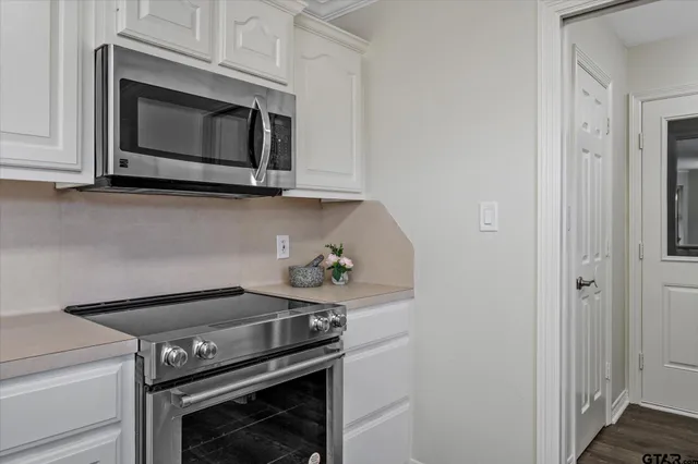 a kitchen with a stove and a microwave