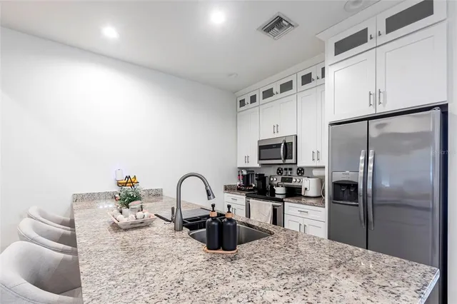 a kitchen with stainless steel appliances granite countertop a stove and a sink