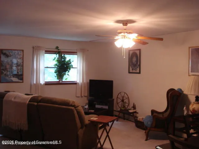a view of a livingroom with furniture and a window